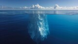 White iceberg floating in clear blue water sea, split view below and above the water surface
