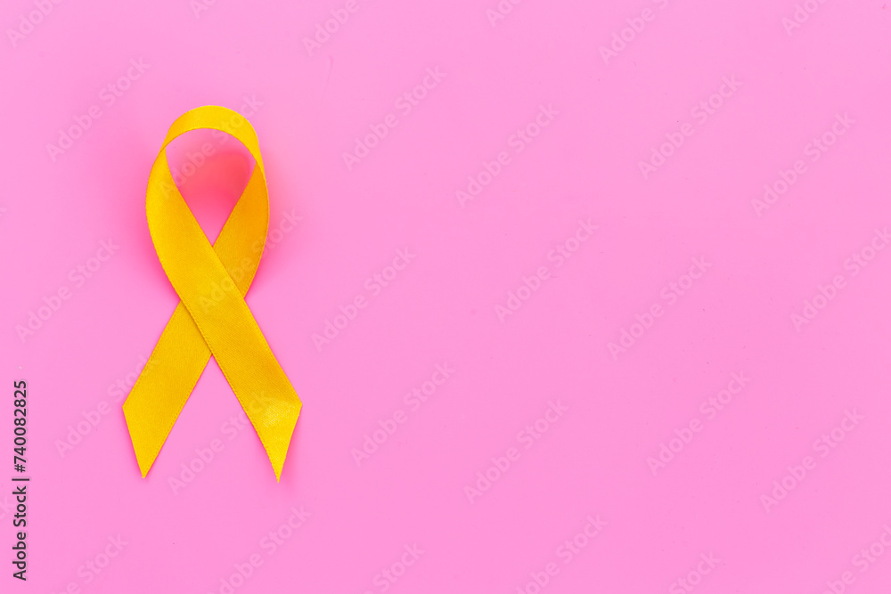Yellow ribbon symbol of bone cancer and suicide problems awareness concept Yellow ribbon symbol of bone cancer and suicide problems awareness concept