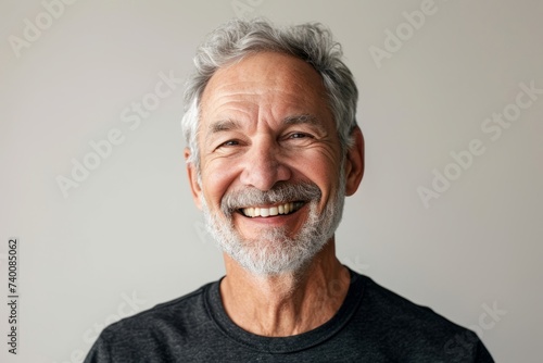 Portrait of a happy senior man with white beard smiling at camera