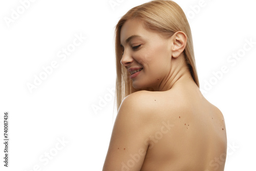 Back view photo of smiling, tender young woman with naked back against white studio background. Prevention of skin diseases. Concept of natural beauty, anti aging, cosmetology, female health. Ad