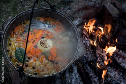 Fish soup in a pot cooked on a fire