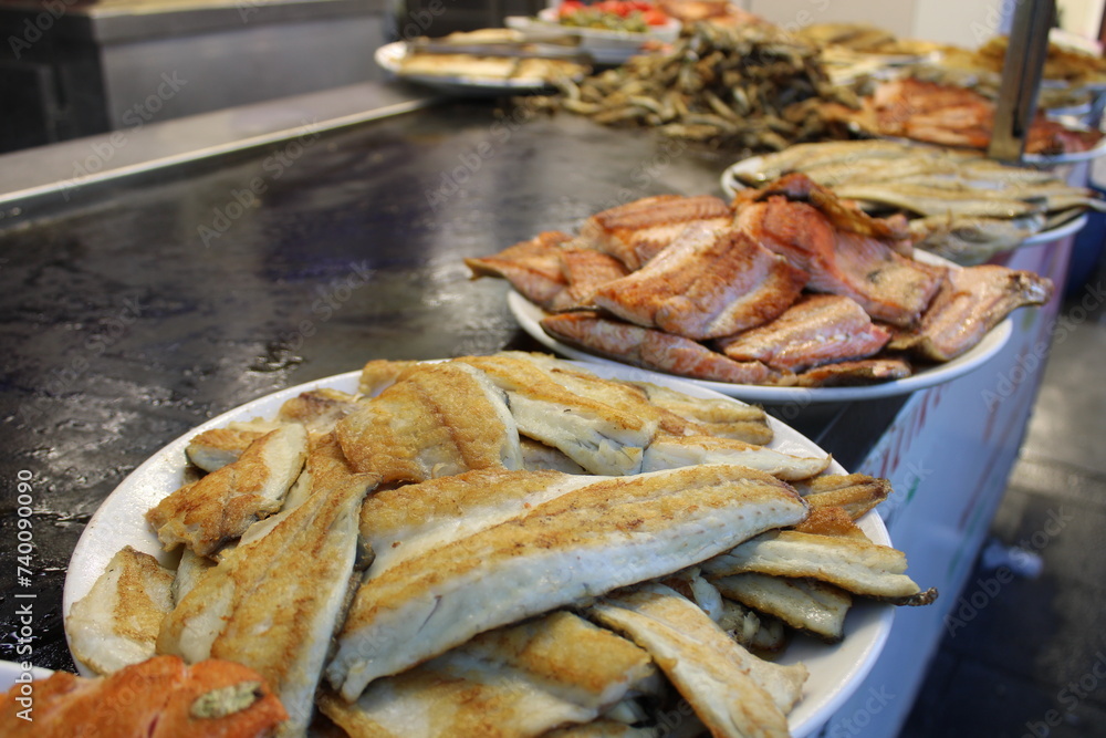 fried fish on the counter. fresh and delicious salmon fried fish on the counter. fresh and delicious salmon
