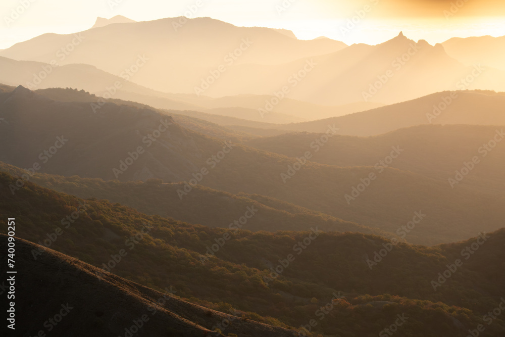 Mountain slopes in the mist at sunset
