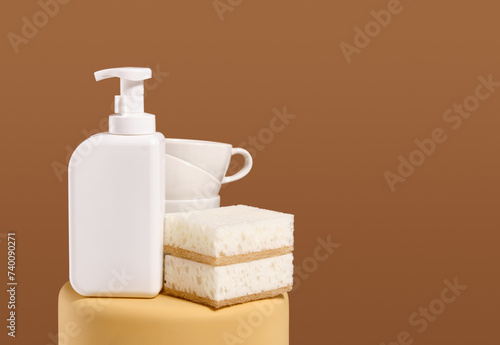 Kitchen dish work. White gel dispenser and sponges for dishwashing. Copy space for text.