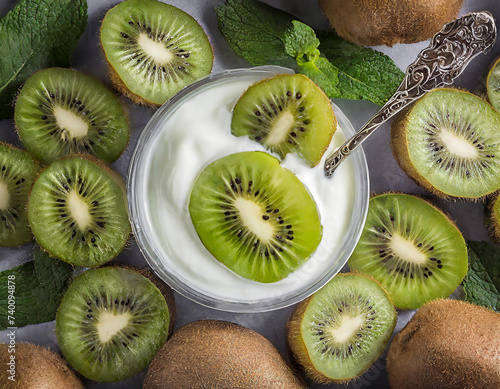 Yogurt with kiwi slices, top view, fruit background © Genevieve