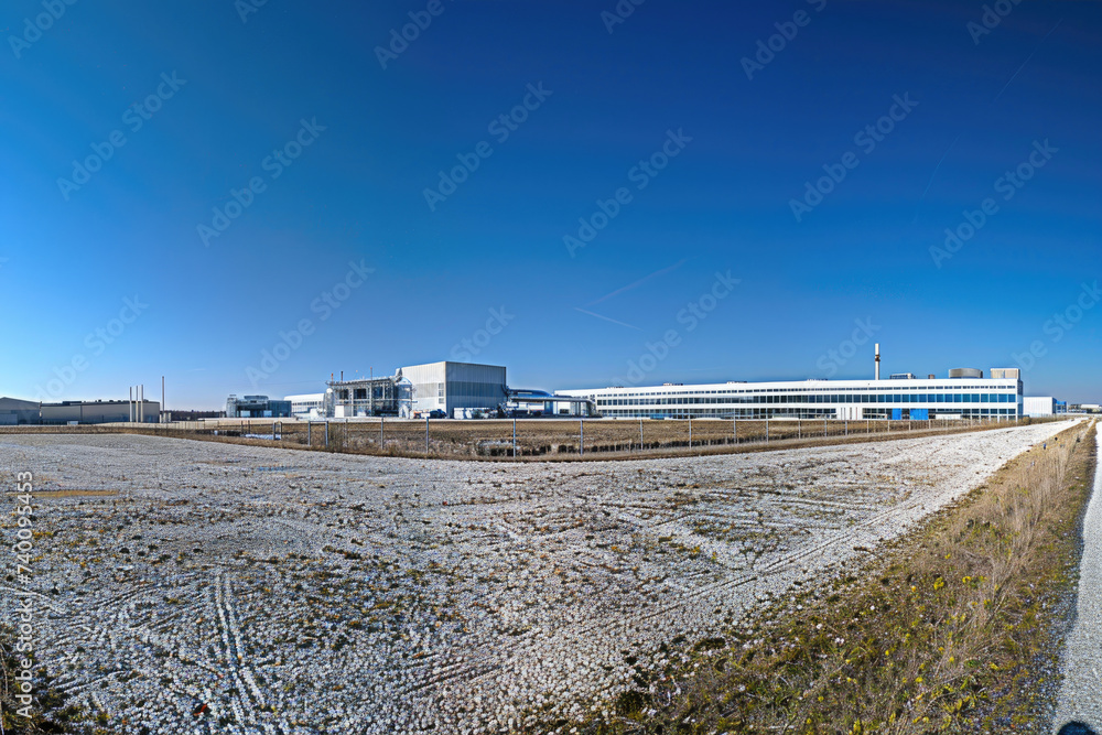 A panoramic view of a green hydrogen production facility against a clear sky