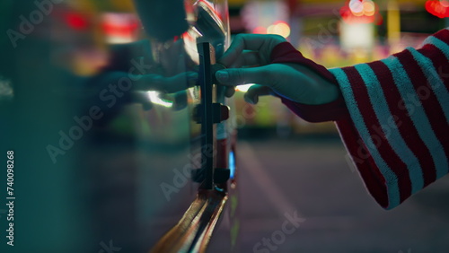 Canvas Print Closeup hand inserting coin into game vending machine