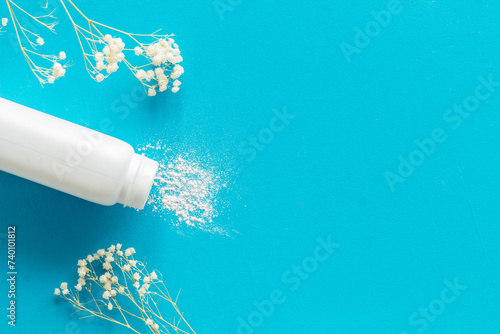 Baby talcum powder container with white flowers, top view. Child care concept