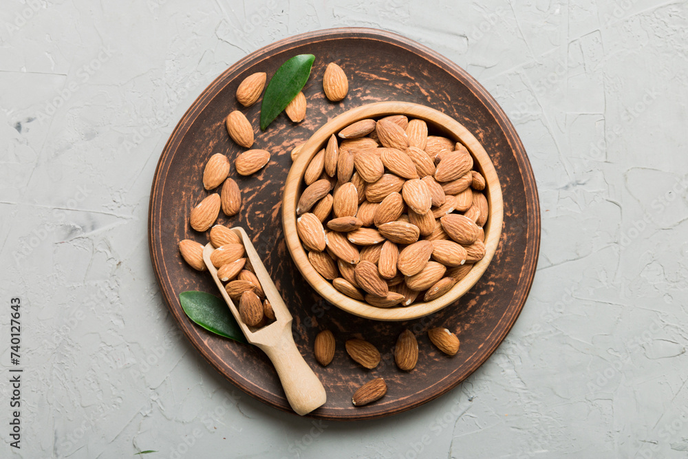 Fresh healthy Almond in bowl on colored table background. Top view Fresh healthy Almond in bowl on colored table background. Top view