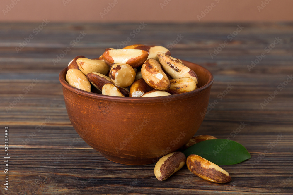 Fresh healthy Brazil nuts in bowl on colored table background. Top view Healthy eating bertholletia concept. Super foods Fresh healthy Brazil nuts in bowl on colored table background. Top view Healthy eating bertholletia concept. Super foods