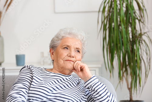 Senior woman sitting on sof...