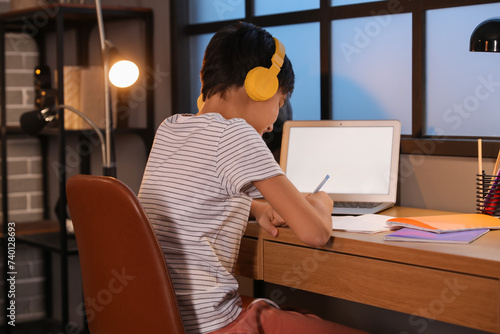 Little boy with headphones ...