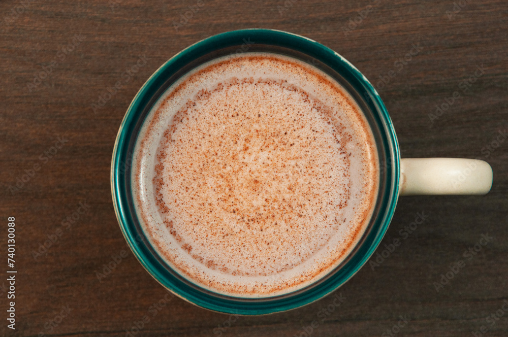 latte in a clay cup on the table. cocoa drink in a cup on a wooden background latte in a clay cup on the table. cocoa drink in a cup on a wooden background