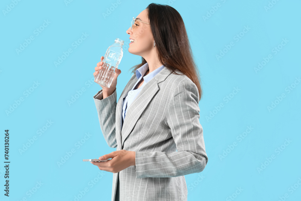 Young businesswoman with bottle of water on color background Young businesswoman with bottle of water on color background