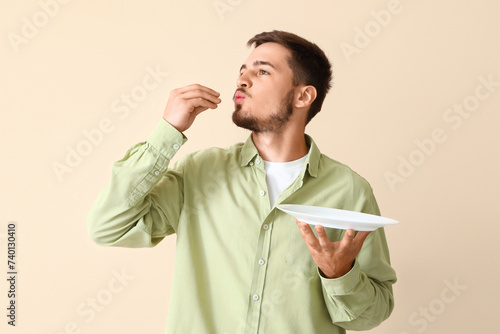 Young man with plate gestur...