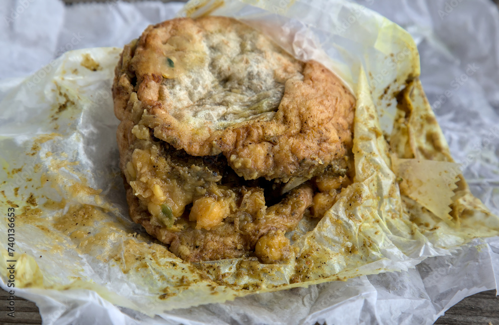 Stockfoto doubles unwrapped on parchment paper (Trinidadian specialty