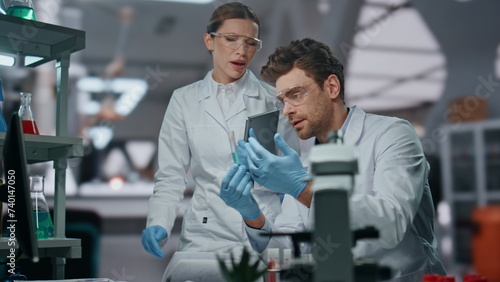 Woman scientist teach assistant to make research in lab. Dissatisfied doctor
