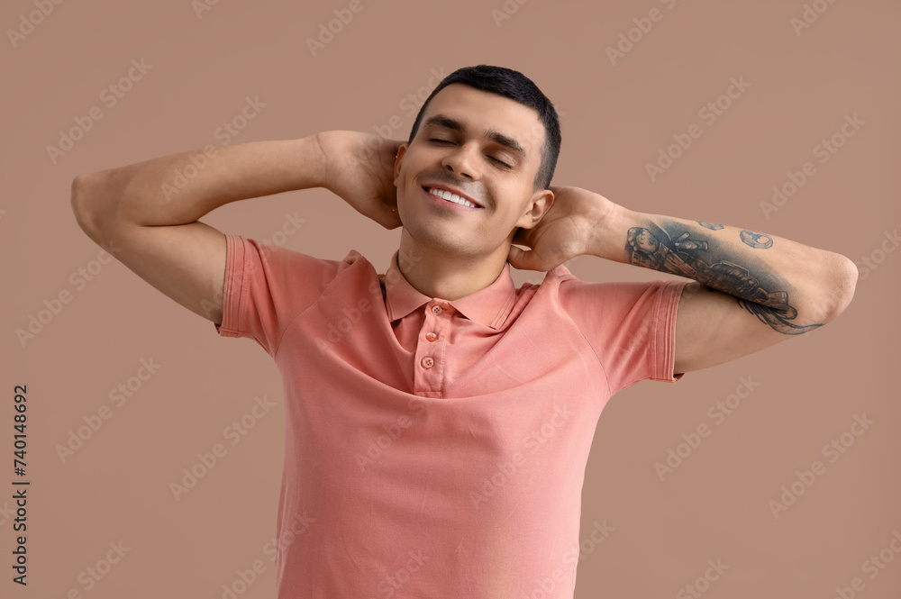 Handsome young man with healthy teeth on brown background. Dental care concept Handsome young man with healthy teeth on brown background. Dental care concept