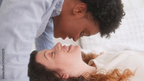 Portrait of lesbian couple kissing in bed  