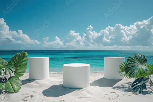 Three round marble platforms resting on a sandy beach as the backdrop of foamy sea waves creates a serene yet dynamic setting.