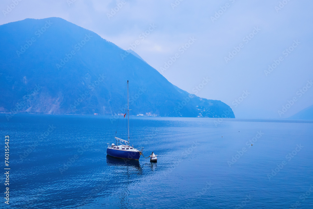 The small boat is tied up to the buoy, Lugano Lake, Lugano, Switzerland