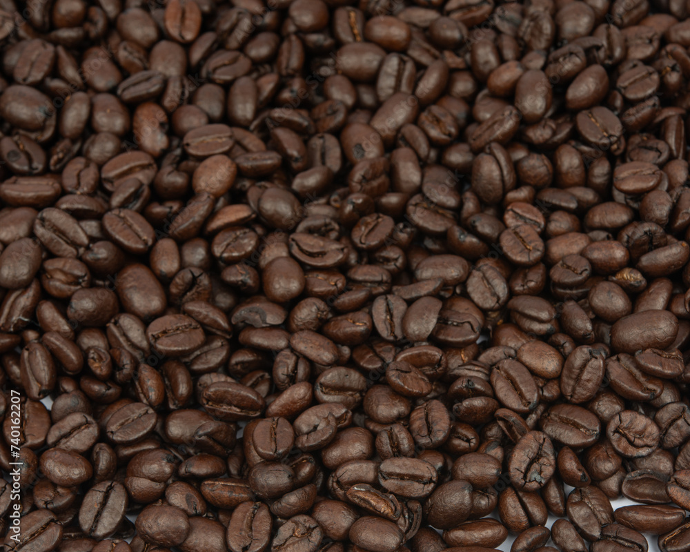 Coffee bean background. Roasted coffee beans on the entire surface. Brown coffee. Flat layout with top view. Coffee bean background. Roasted coffee beans on the entire surface. Brown coffee. Flat layout with top view.