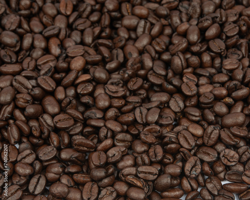 Coffee bean background. Roasted coffee beans on the entire surface. Brown coffee. Flat layout with top view.