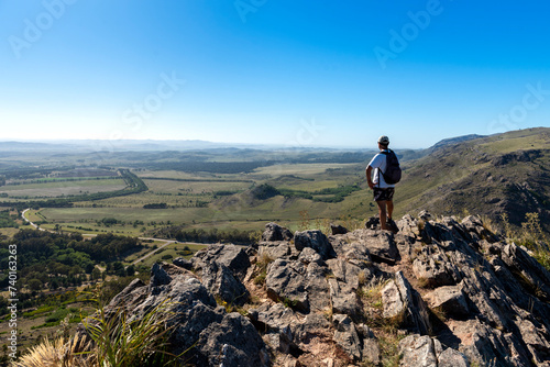 adult man traveler in the mountain traveling walking and contemplating the beautiful big landscape of mountains forests lifestyle outdoors