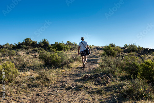 adult man traveler in the mountain traveling walking and contemplating the beautiful big landscape of mountains forests lifestyle outdoors