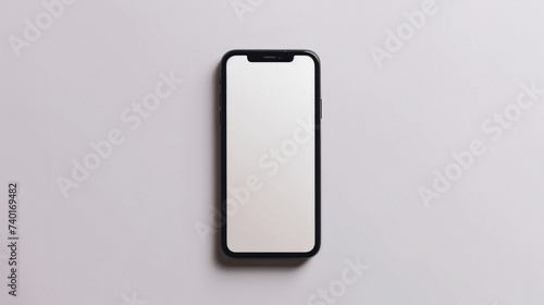 Smartphone with blank screen on white background. Flat lay, top view .