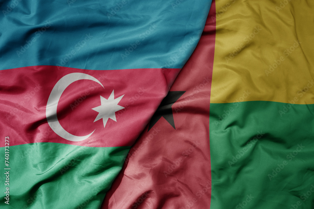 big waving national colorful flag of guinea bissau and national flag of azerbaijan. big waving national colorful flag of guinea bissau and national flag of azerbaijan.