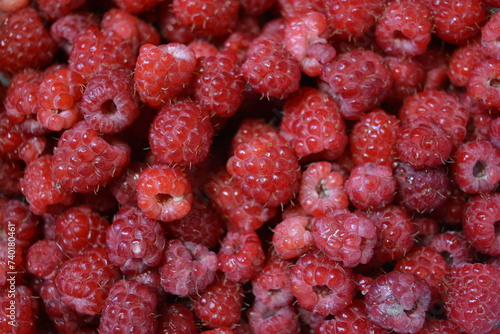 Healthy food, fresh fruits, red, juicy, ripe raspberries from homemade raspberries are located on a white background.