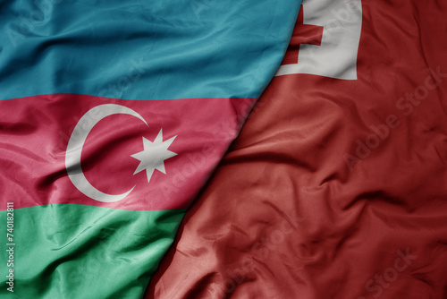 big waving national colorful flag of Tonga and national flag of azerbaijan.