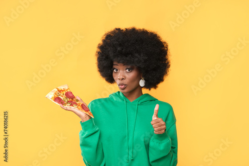 Model with an appetizing pizza in her hand.