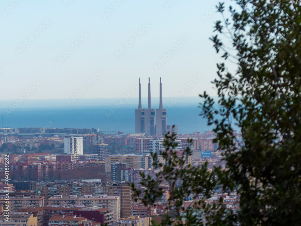 Urban landscape with thermal power plant chimneys and trees branches. Urban landscape with thermal power plant chimneys and trees branches.