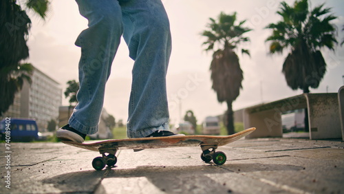 Tableau sur toile Feet skateboarder performing trick with longboard at summer sunlight outdoors