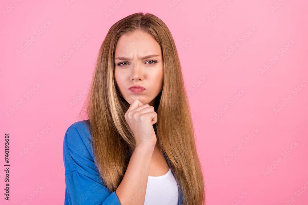 Photo of moody thoughtful lady dressed blue shirt arm chin empty space isolated pink color background Photo of moody thoughtful lady dressed blue shirt arm chin empty space isolated pink color background