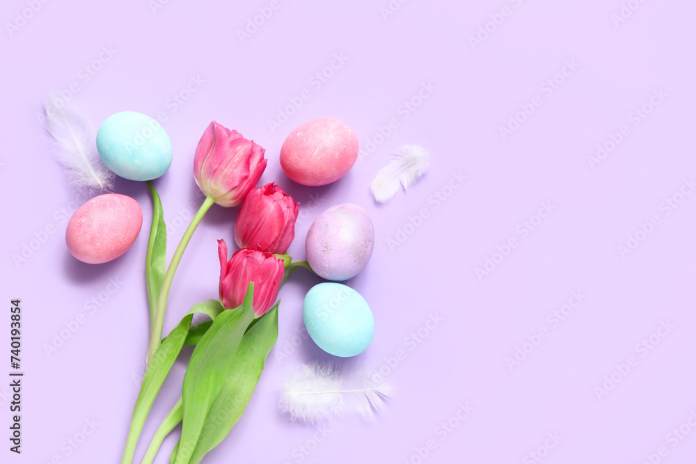 Beautiful tulip flowers with painted Easter eggs and feathers on purple background