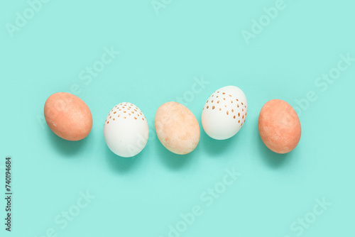 Painted Easter eggs on turquoise background