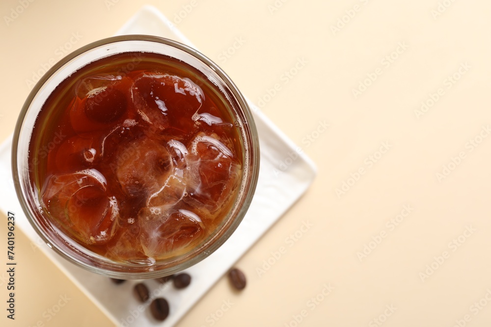 Refreshing iced coffee in glass on beige table, top view. Space for text Refreshing iced coffee in glass on beige table, top view. Space for text