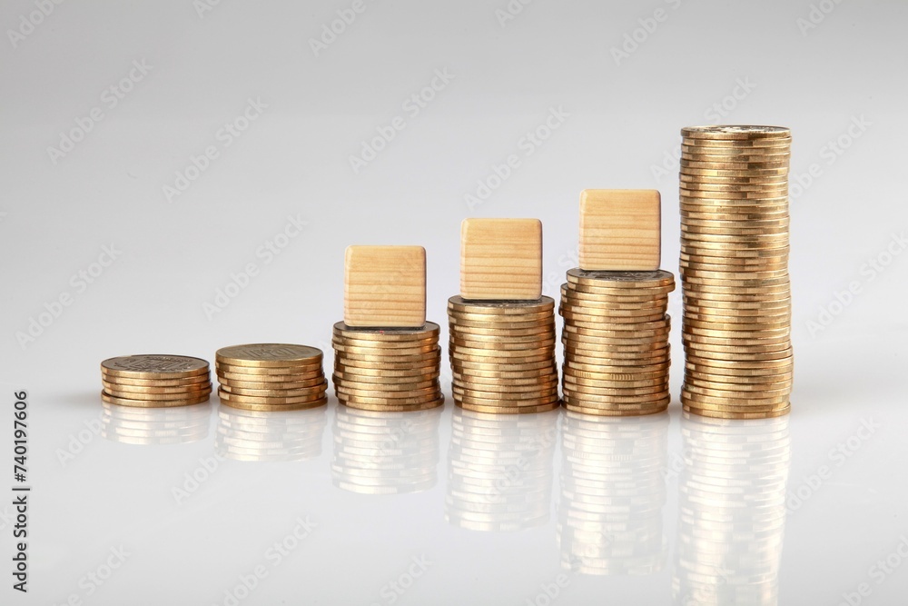 Stacks of coins and ETF text on wooden cubes Stacks of coins and ETF text on wooden cubes