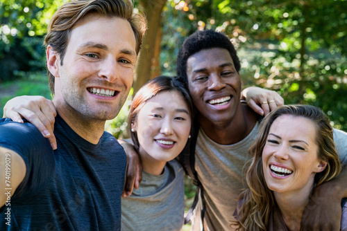 Selfie capture of group of friends embracing after hiking on woods