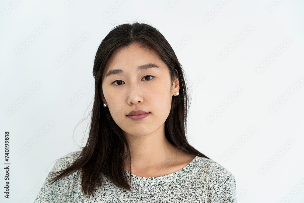 Front view portrait with white background of young adult woman looking at the camera Front view portrait with white background of young adult woman looking at the camera