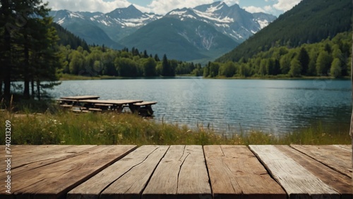 Empty wooden table overlooking mountain and lake