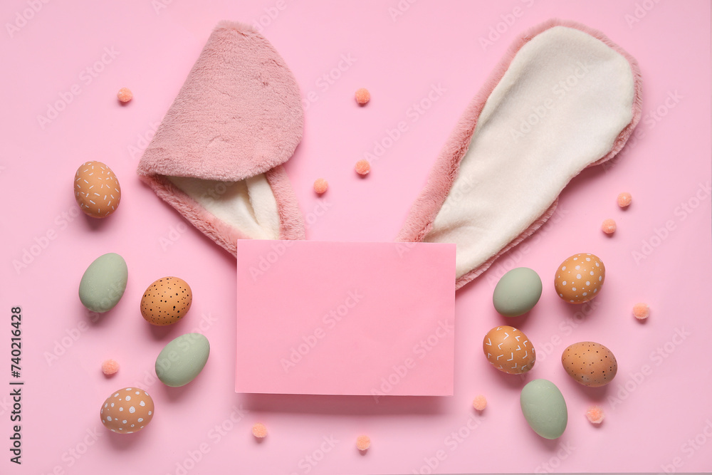 Bunny ears, Easter eggs and blank card on pink background. Top view Bunny ears, Easter eggs and blank card on pink background. Top view