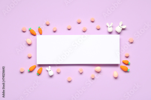 Easter bunnies, carrots and blank card on lilac background. Top view © Pixel-Shot