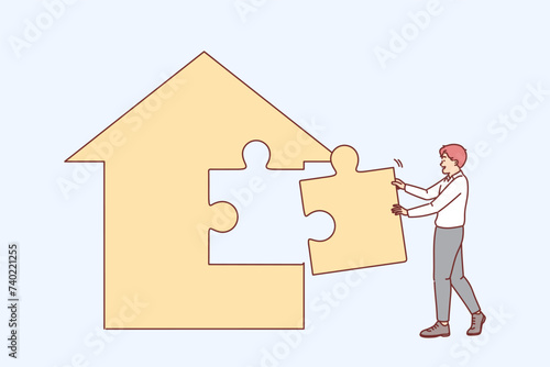 Man real estate agent is building house from puzzles, creating own apartment sales agency.