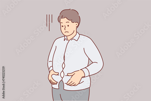 Overweight man is upset holding stomach, dressed in small shirt and needs to consult nutritionist
