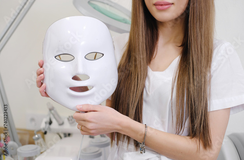 Aesthetician Presenting LED Facial Mask