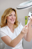 Smiling Cosmetologist Preparing a Syringe with Serum